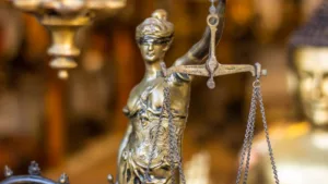 Bronze Lady Justice statue with scales - defense against sexual harassment charges in Austria